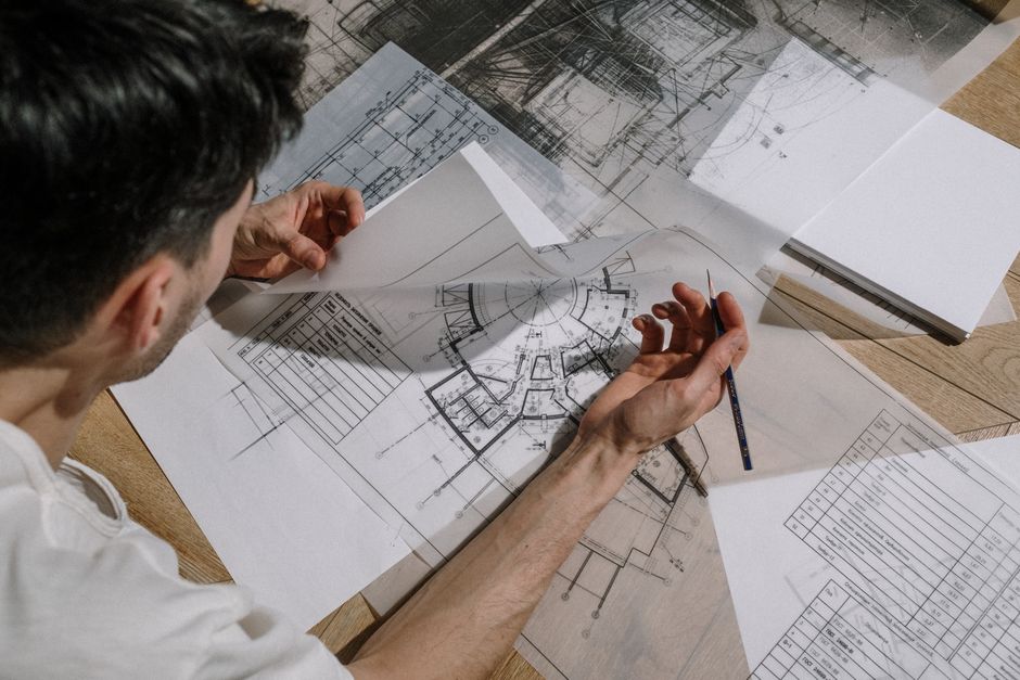 landscape architect reviewing blueprints in a studio setting