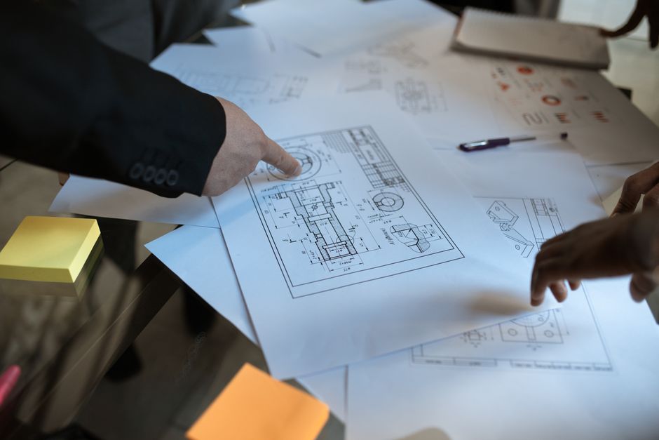 hands working on landscape architectural drawings