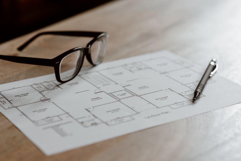 professional landscape architecture drafting blueprints on a wooden desk
